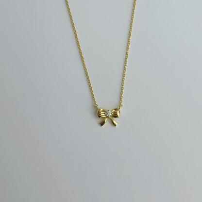 Gold ribbon bow necklace