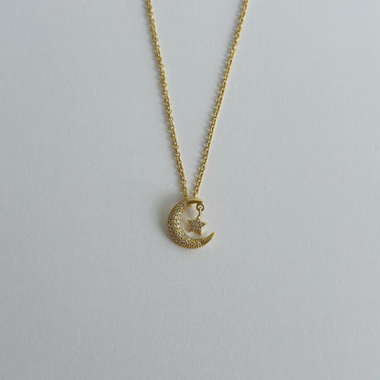 Gold moon & star pave necklace