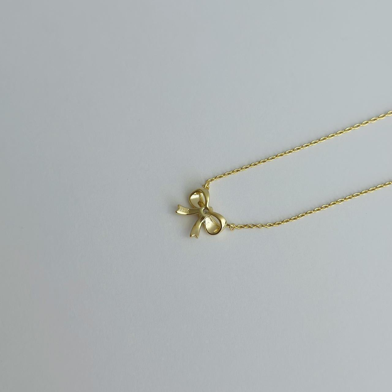 Gold ribbon bow necklace