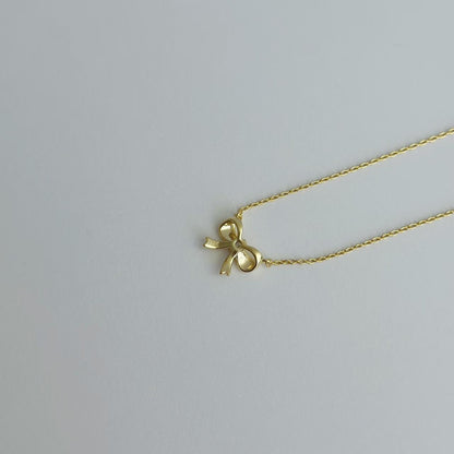 Gold ribbon bow necklace