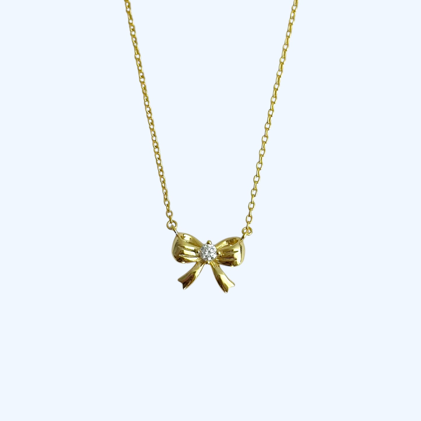 Gold ribbon bow necklace